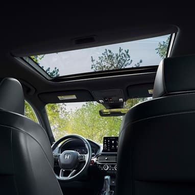 2026 Honda Civic Hatchback Sport Touring Hybrid interior detail of the power moonroof and overhead console (Compact Hatchback).